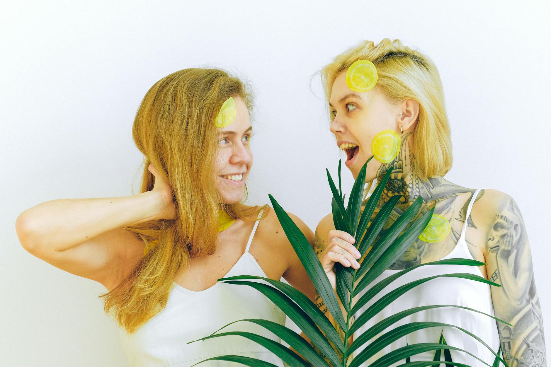 Two women expressing joy and connection, representing wellness and pleasure during life transitions