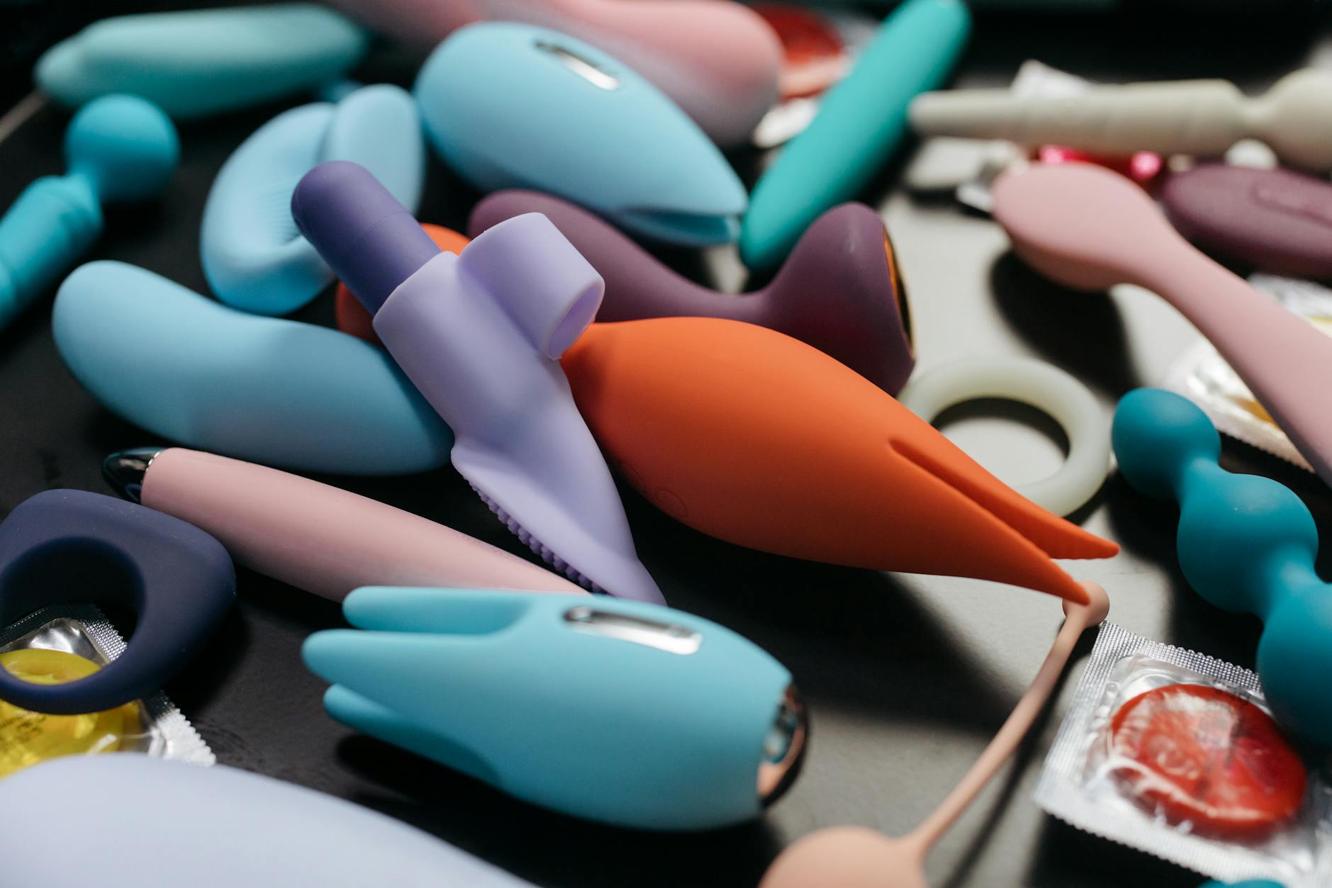 Array of vibrant adult toys including lemon clitoral vibrators and other pleasure devices
